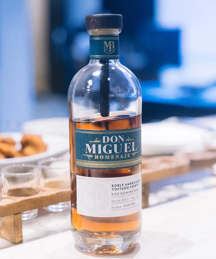 A bottle of don miguel rum sitting on top of a table.