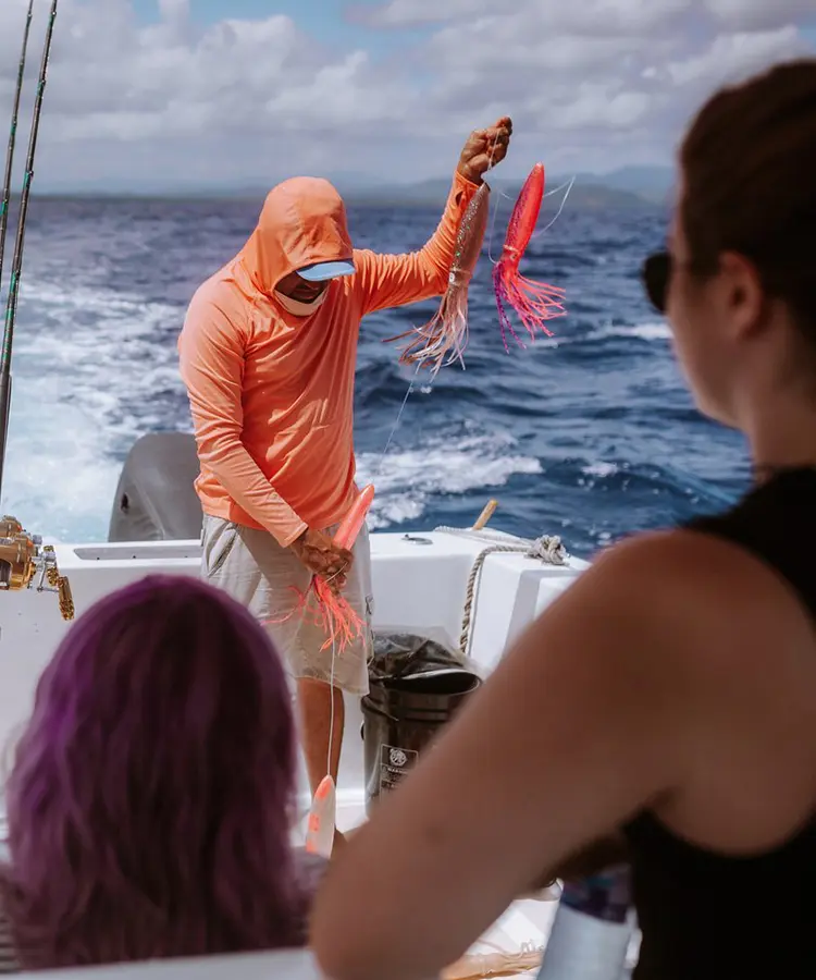 A man in an orange hoodie is on the boat