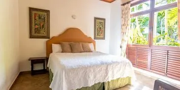 A bed room with a large white bed and two pillows