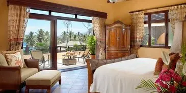 A bedroom with a large sliding glass door and patio.