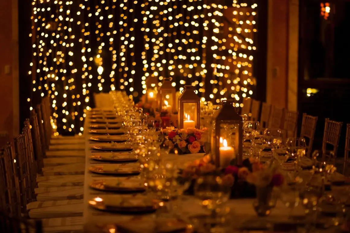 A long table with many plates and candles
