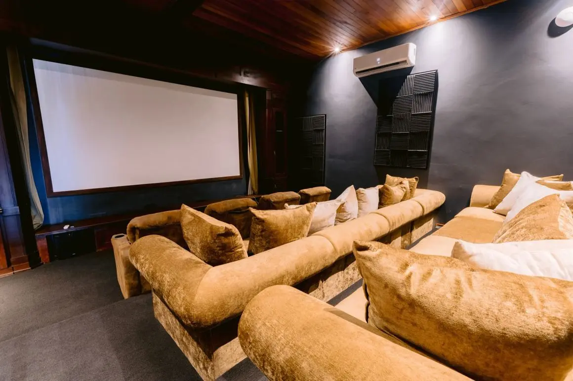 A room with couches and a projector screen