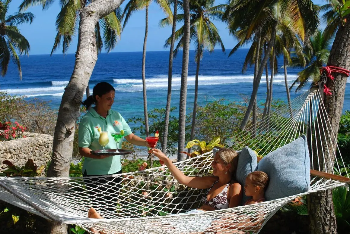 A woman in a hammock with two other women.