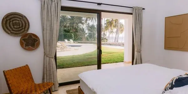A bedroom with sliding glass doors open to the patio.