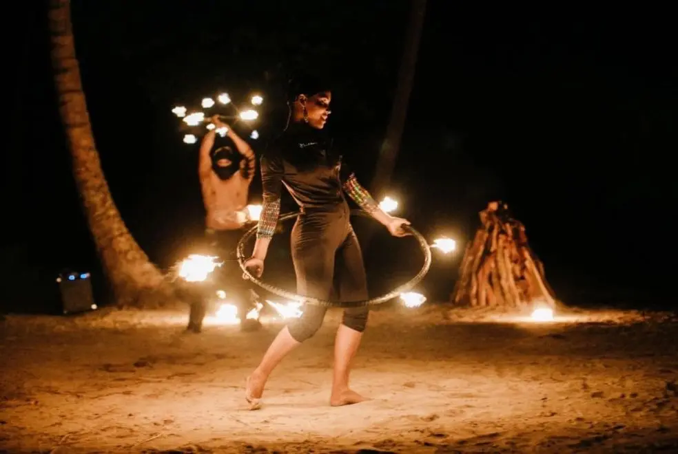 A woman is hula hooping in the desert