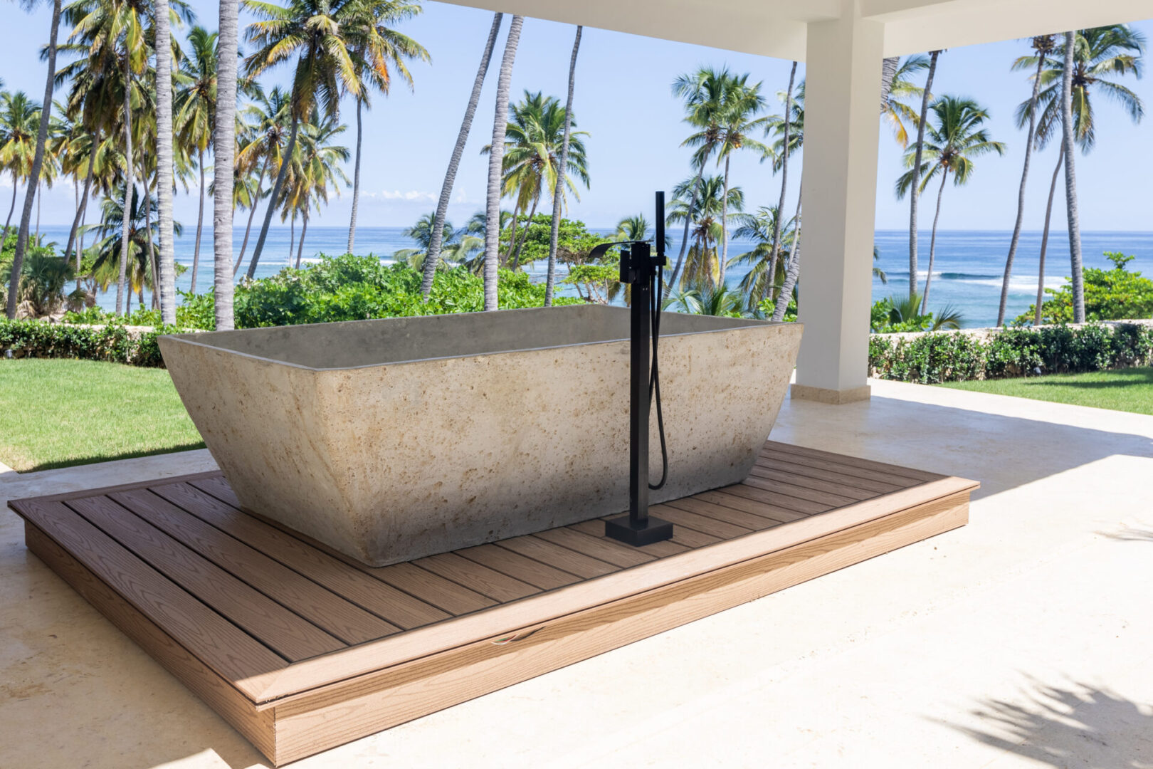A concrete tub sitting on top of a wooden deck.